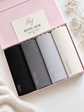 Monochrome Luxe Ribbed Jersey Hijab Box featuring Black, Slate Grey, Pearl Grey and Ivory White premium anti-slip narrow ribbed jersey hijabs in a luxury gift box