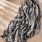Extra-large black and white abstract printed modal lawn hijab featuring a soft breathable fabric, flowy drape and contemporary monochrome pattern.