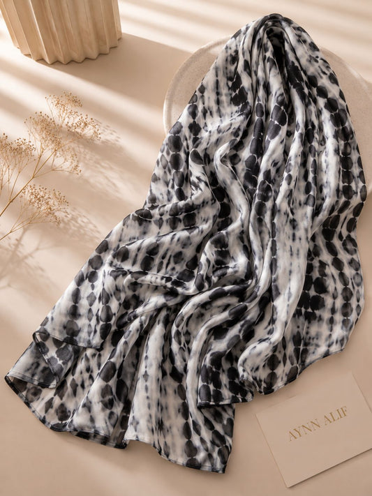 Extra-large black and white abstract printed modal lawn hijab featuring a soft breathable fabric, flowy drape and contemporary monochrome pattern.