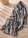 Extra-large black and white abstract printed modal lawn hijab featuring a soft breathable fabric, flowy drape and contemporary monochrome pattern.
