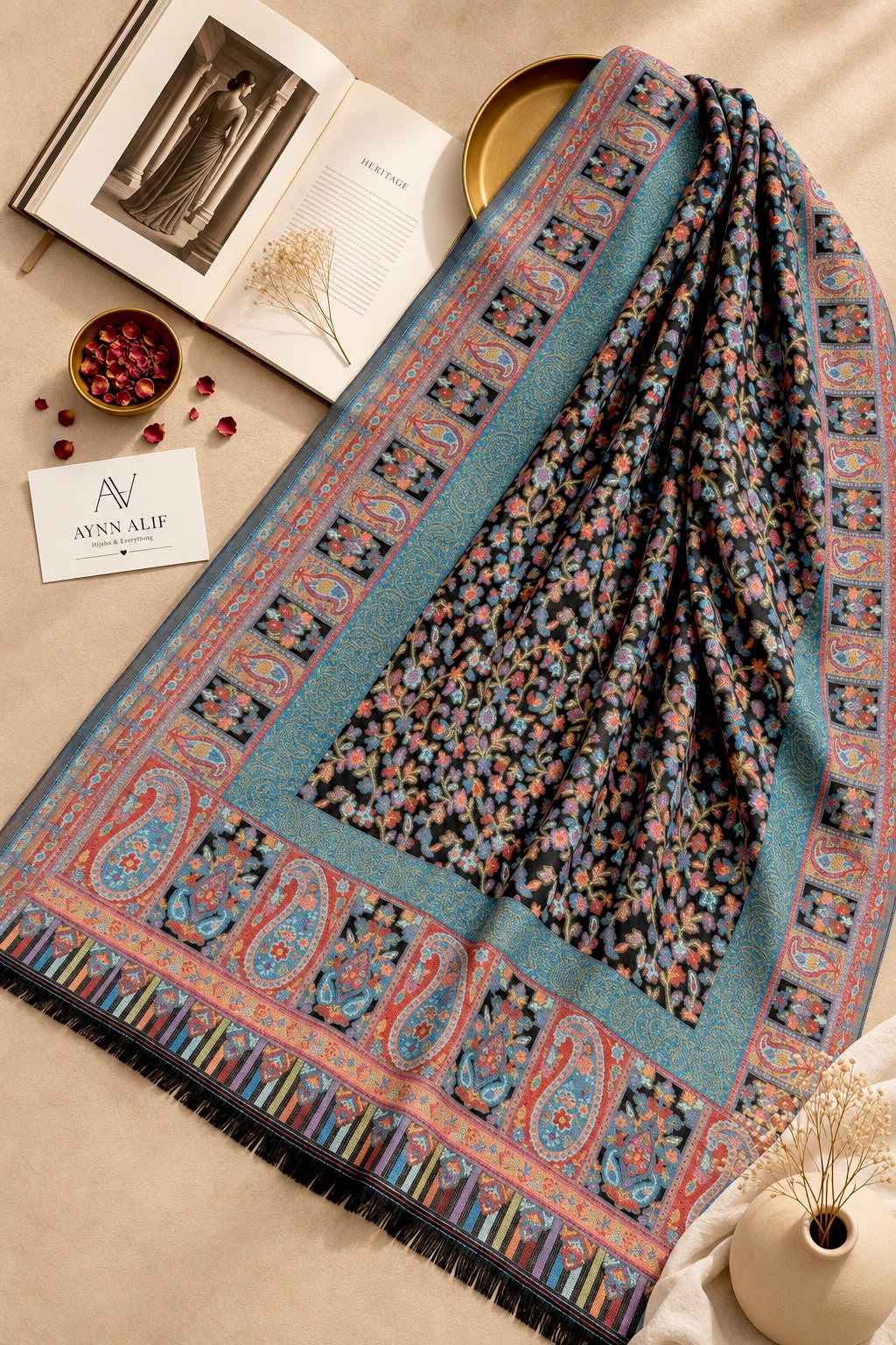 Aynn Alif Kashmiri Kani mini shawl featuring a midnight black base, teal blue, coral pink and peach floral motifs, intricate paisley borders, and decorative patterns.