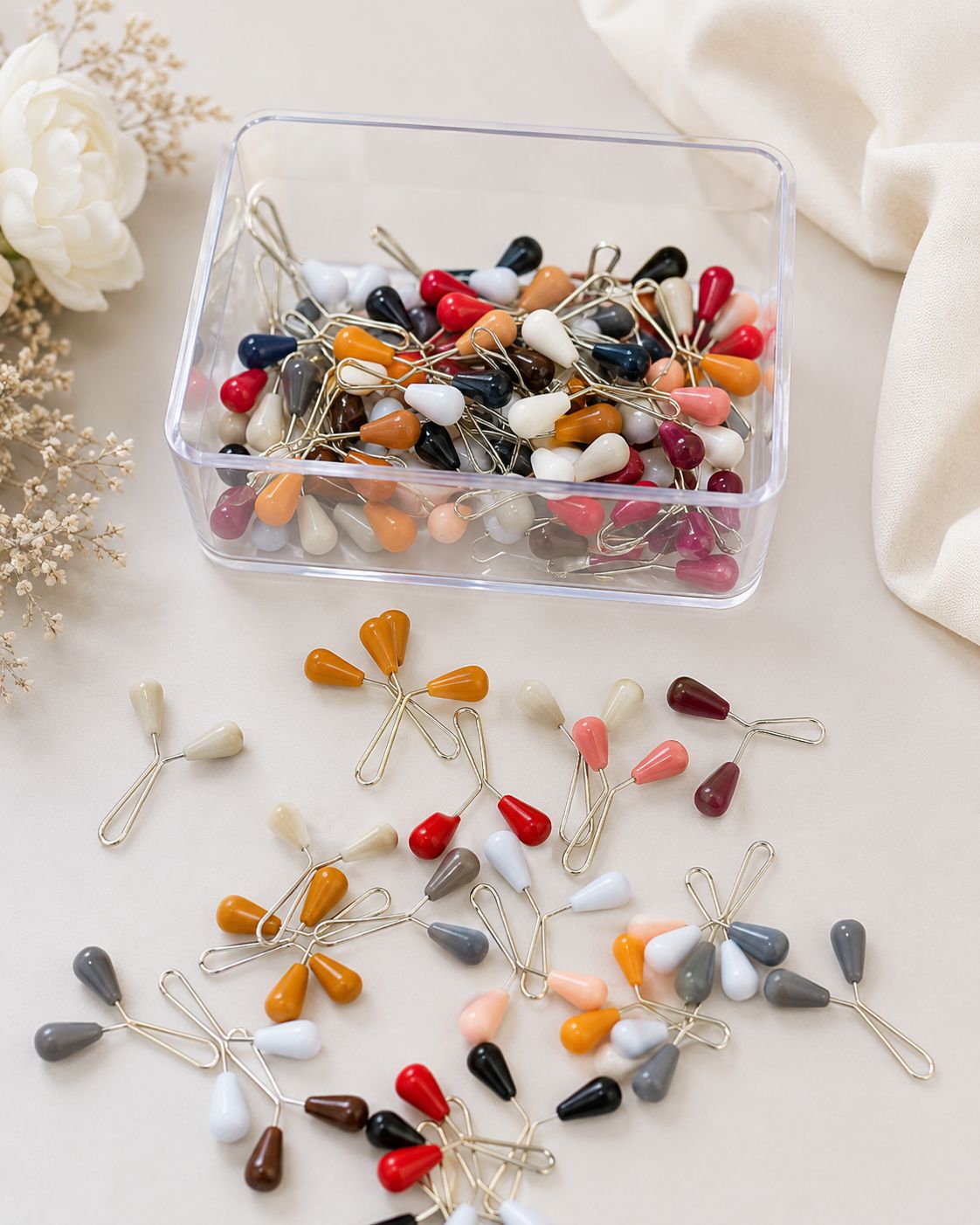 Multi color loop glider pins for hijab and scarves in assorted shades with teardrop pearl heads and metal loops.
Snag-free, secure and stylish.