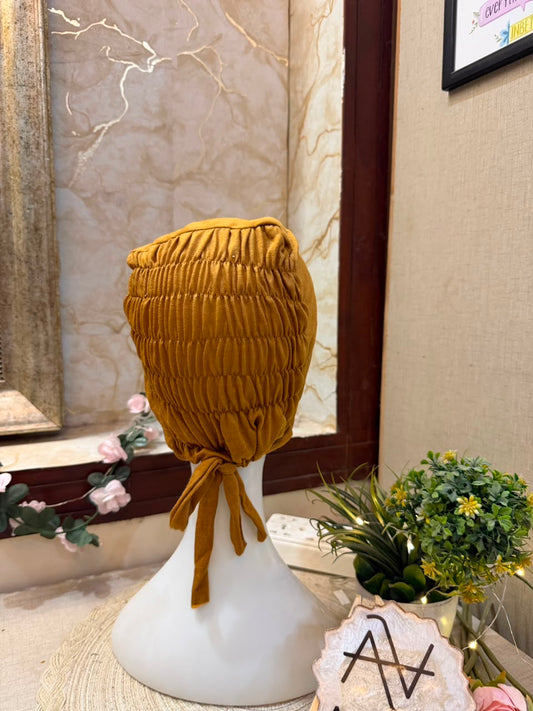 Mustard Yellow ruched tie back hijab cap made from soft breathable jersey with full head coverage and adjustable tie-back by Aynn Alif.