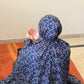 Navy blue floral printed namaz chaadar for women by Aynn Alif Pakistan wudu friendly prayer chaadar with elastic sleeves and full coverage coverage for salah and daily prayer wear.