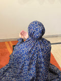 Navy blue floral printed namaz chaadar for women by Aynn Alif Pakistan wudu friendly prayer chaadar with elastic sleeves and full coverage coverage for salah and daily prayer wear.