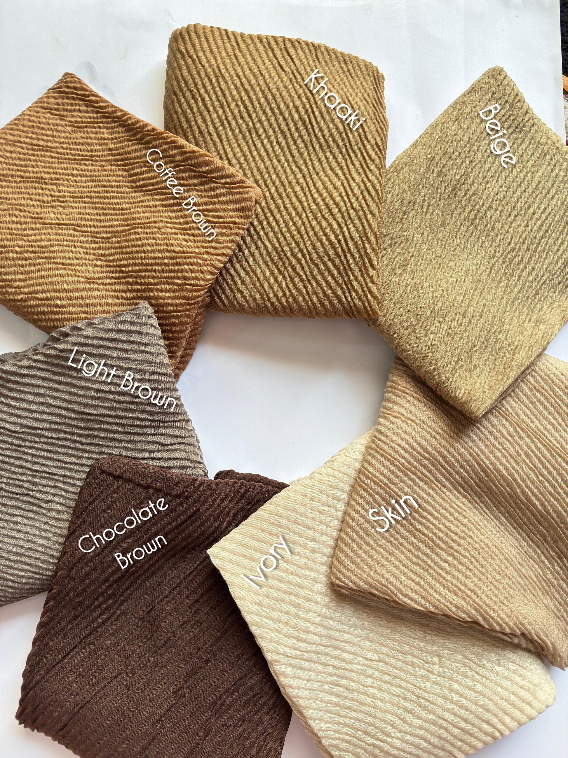 Bubble pleated lawn hijabs by Aynn Alif Pakistan in chocolate brown, beige, ivory and neutral earthy shades with lightweight breathable fabric for modest styling.