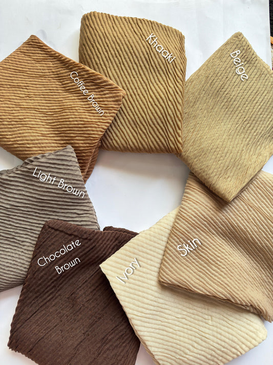 Bubble pleated lawn hijabs by Aynn Alif Pakistan in chocolate brown, beige, ivory and neutral earthy shades with lightweight breathable fabric for modest styling.