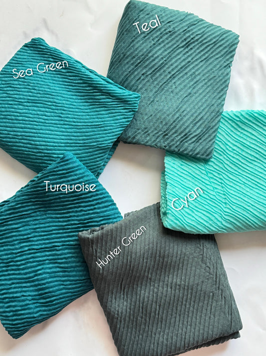 Bubble pleated lawn hijabs by Aynn Alif Pakistan in hunter green, teal, turquoise and cyan shades with lightweight breathable fabric for modest styling