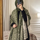 Olive green and ivory paisley reversible woolen wrap styled over a black modest outfit