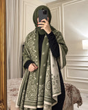Olive green and ivory paisley reversible woolen wrap styled over a black modest outfit