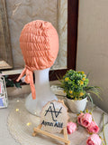 Orangish Peach ruched tie back hijab cap made from soft breathable jersey with full head coverage and adjustable tie-back by Aynn Alif.