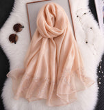 Peach cotton silk hijab with embroidered organza border and soft drape.