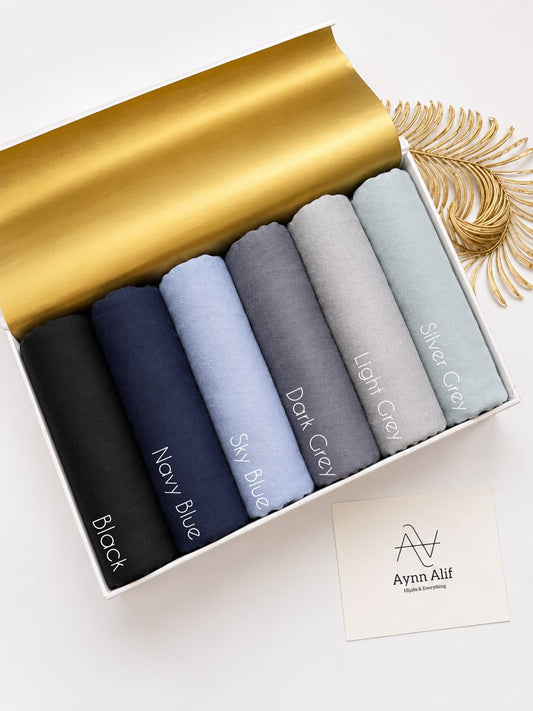 Soft breathable jersey hijabs in blue and grey shades neatly folded