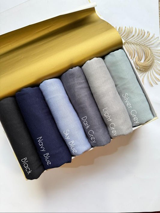 Soft breathable jersey hijabs in blue and grey shades neatly folded