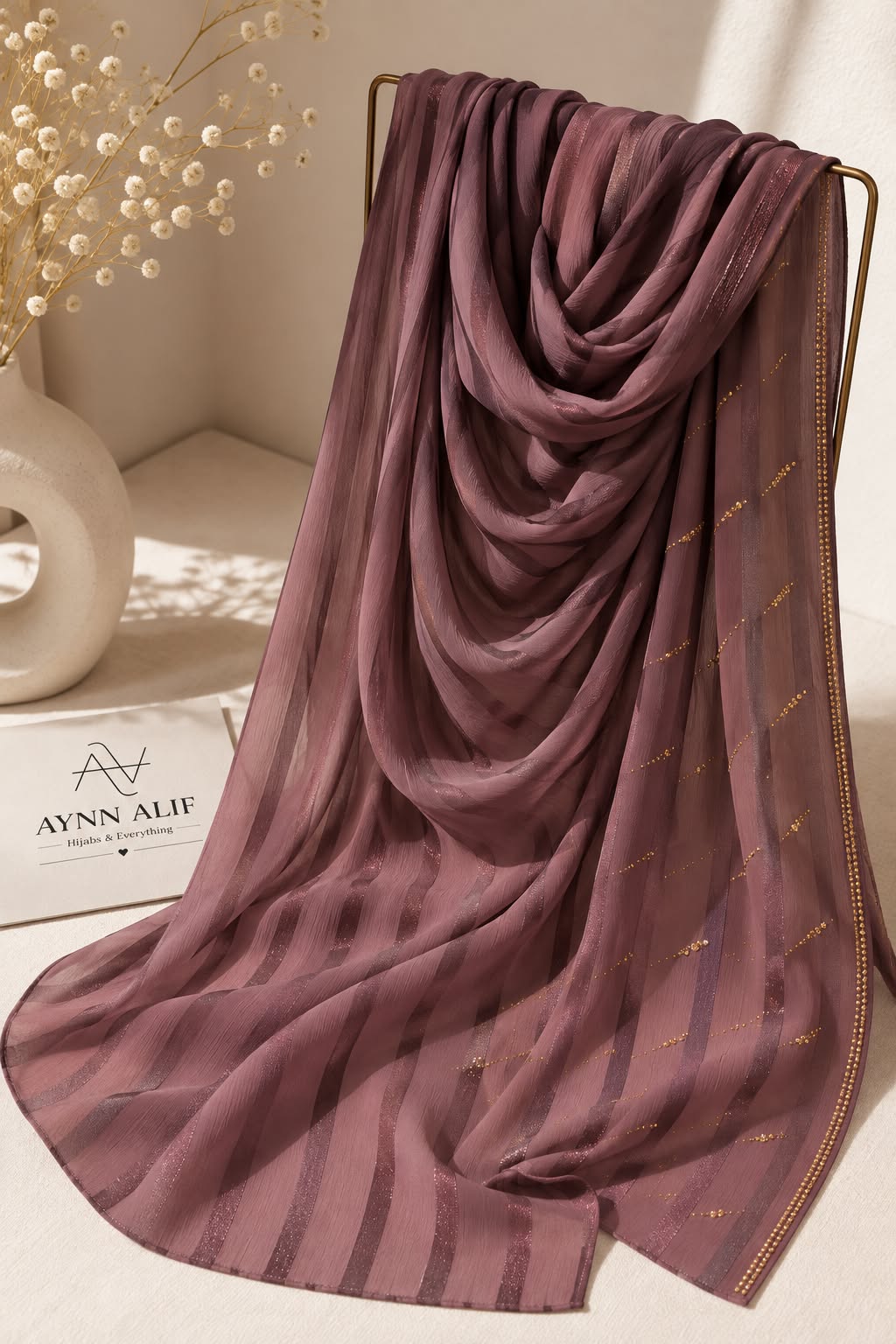 Plum violet crinkle chiffon georgette hijab with satin stripes and delicate stone-studded detailing by Aynn Alif.