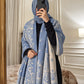 Powder blue and ivory paisley reversible woolen wrap styled over a black modest outfit