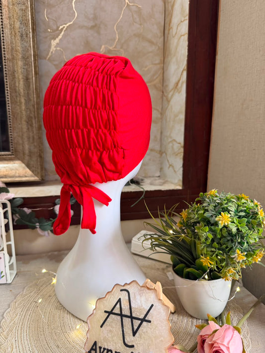 Red ruched tie back hijab cap made from soft breathable jersey with full head coverage and adjustable tie-back by Aynn Alif.