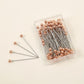Rose gold hijab pins box of 100 by Aynn Alif Pakistan featuring premium rose gold scarf pins for elegant hijab wear.