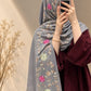 Silver grey cashmere embroidered hijab featuring pink and green floral motifs, delicate sequin embellishments, and matching grey fringed edges by Aynn Alif.