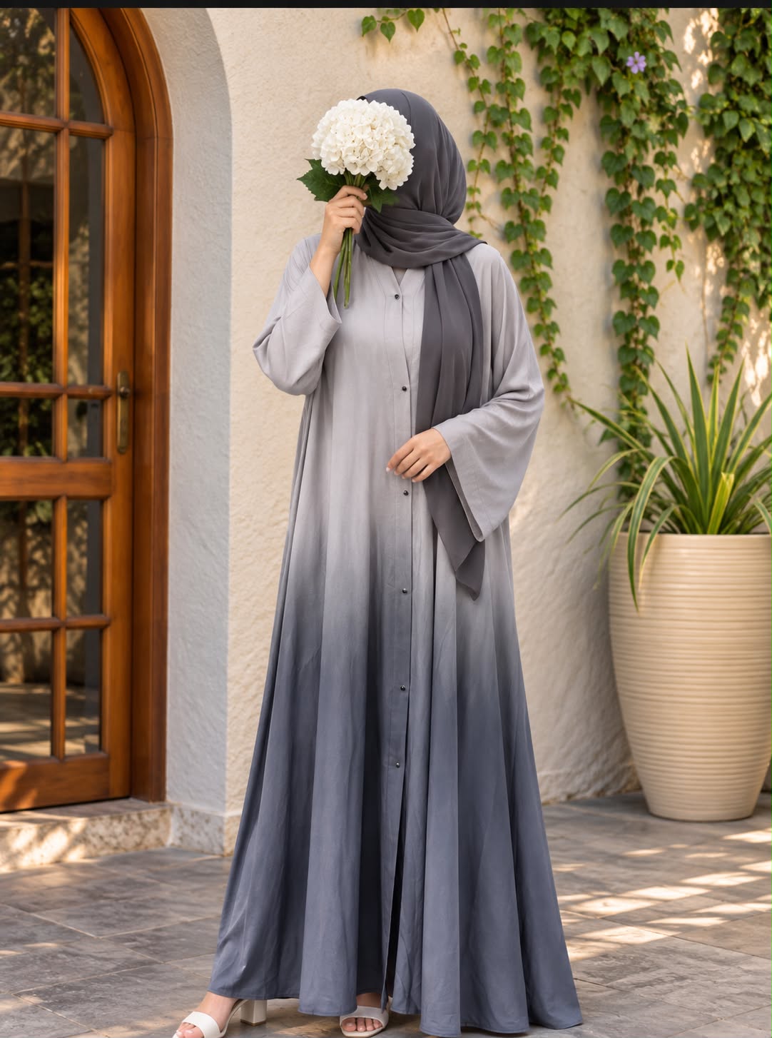 Silver-grey to charcoal ombre front open abaya in Silk Korean Nidah with straight sleeves and matching scarf, styled in an elegant outdoor setting.