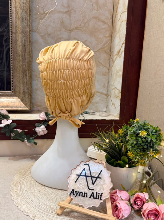 Skin Green ruched tie back hijab cap made from soft breathable jersey with full head coverage and adjustable tie-back by Aynn Alif.