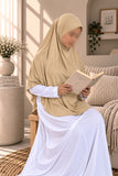 Girl wearing a skin colour Aynn Alif teens jersey makhna scarf with adjustable back elastic, designed for a secure and comfortable fit for ages 11–16.