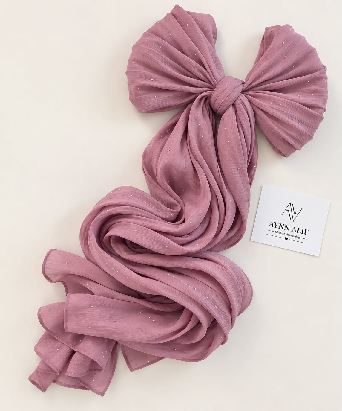 Tea pink stones-studded matte silk hijab with a flowy drape and elegant delicate stone embellishments by Aynn Alif.