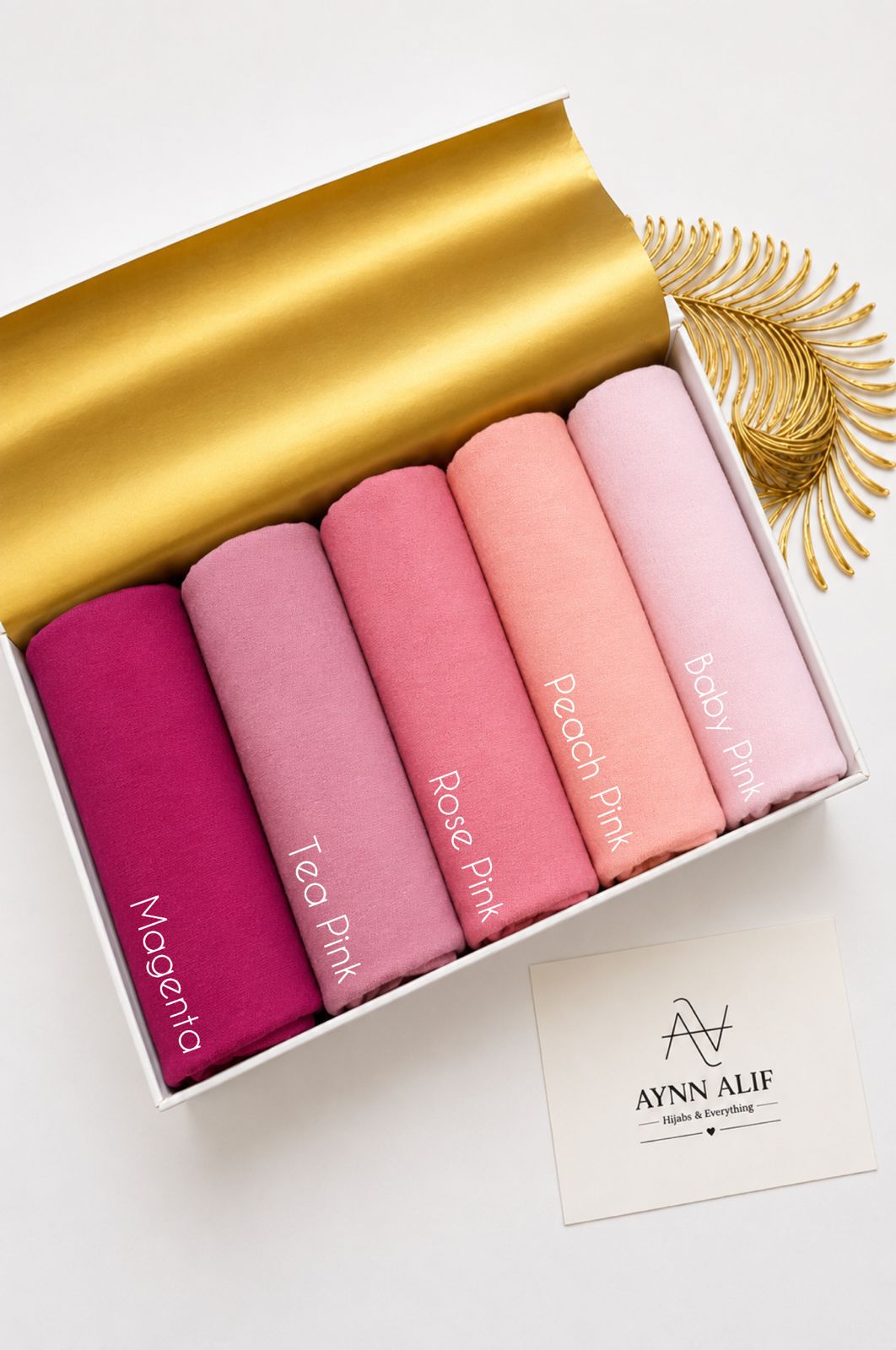 Aynn Alif plain jersey hijabs in Magenta, Tea Pink, Rose Pink, Peach Pink and Baby Pink arranged in a collection.