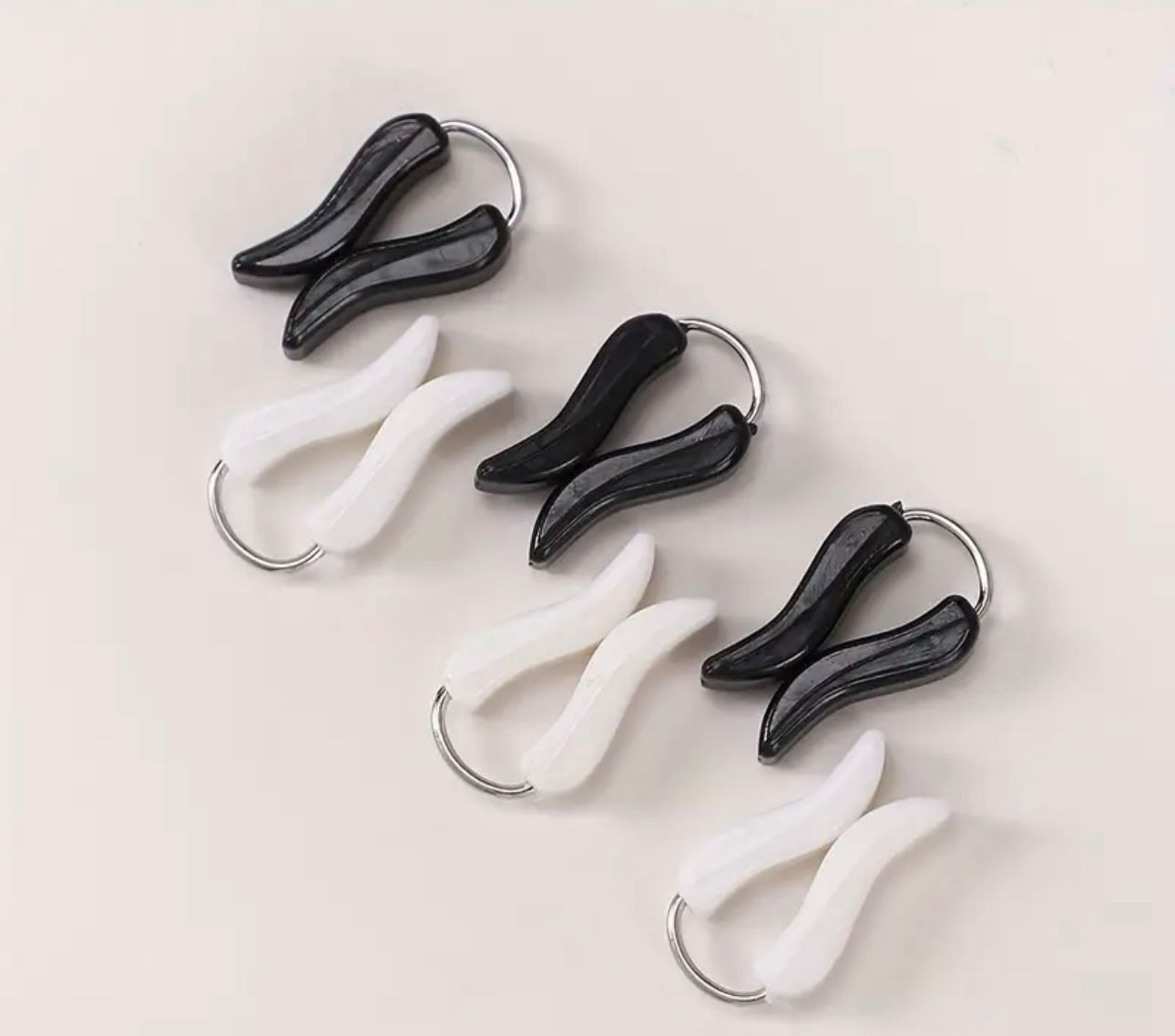 Turkish loop pin and glider pin available in black and white pearl finish, snag-free hijab accessory with smooth silver loop design.