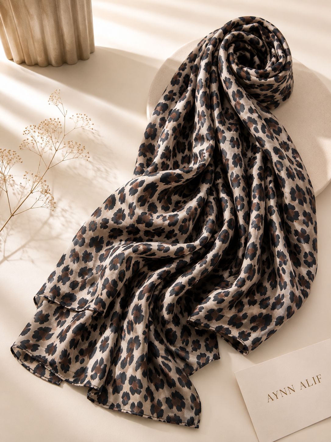 Extra large leopard print modal lawn hijab in beige, mocha brown and black tones with soft breathable fabric and double-sewn edges