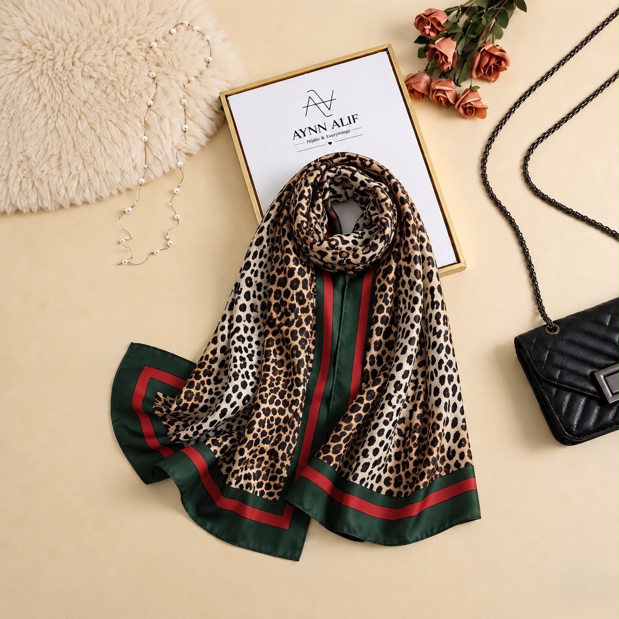 Leopard print silk scarf in beige and brown with emerald green and deep red contrast detailing by Aynn Alif